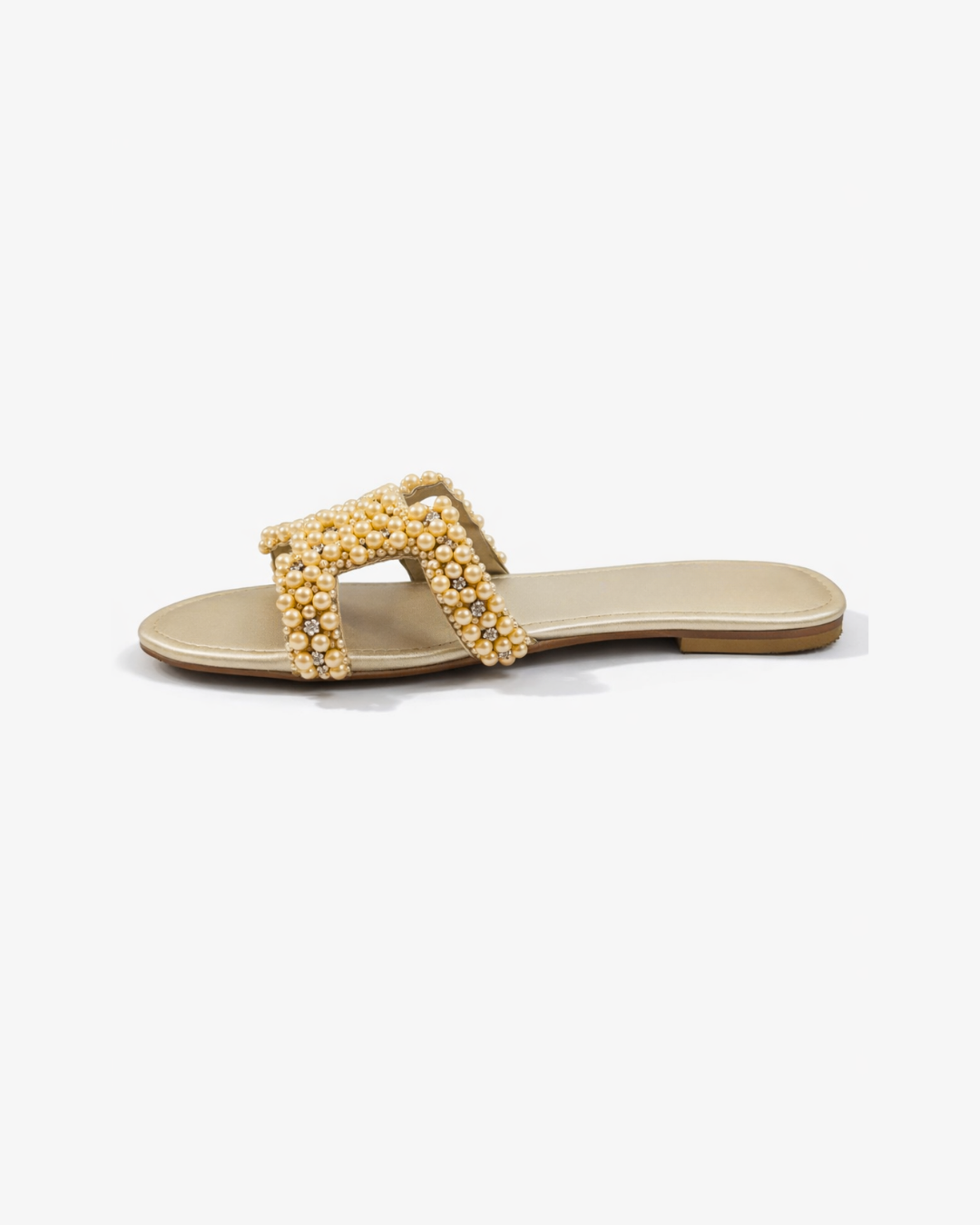 Gold sandal with pearl embellishments on a white background