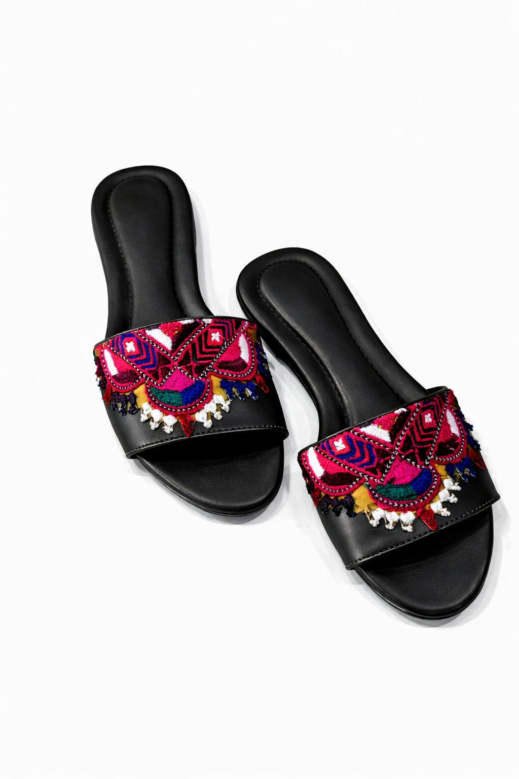 Black slides with colorful embroidered straps on a white background