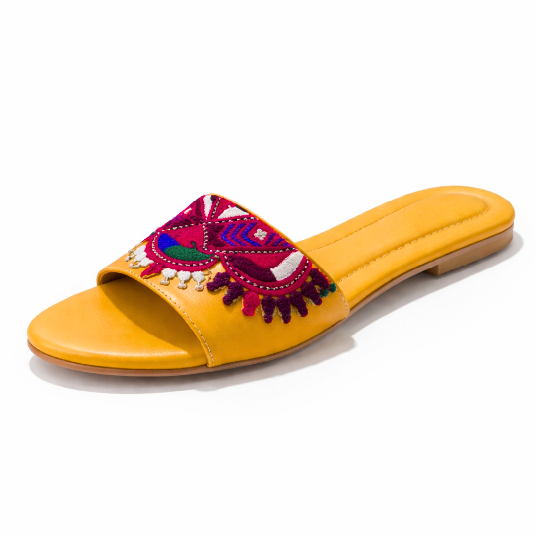 Yellow sandal with colorful embroidery on a white background